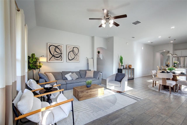 living room featuring ceiling fan and wood-type flooring