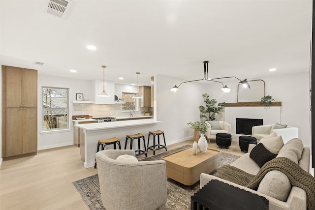 living room featuring sink and light wood-type flooring