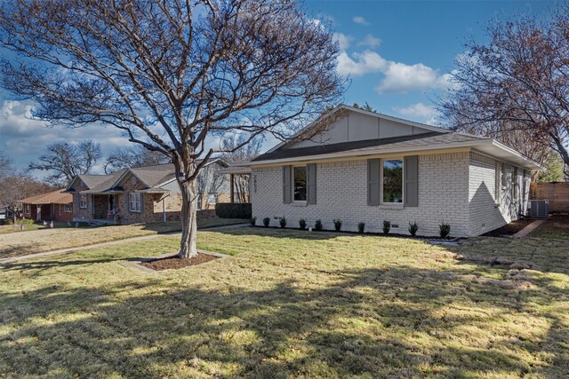 view of side of property featuring a lawn and central AC unit