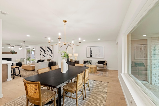 dining room featuring a chandelier and light hardwood / wood-style flooring