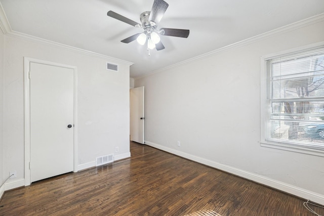 unfurnished bedroom with multiple windows, dark hardwood / wood-style flooring, ceiling fan, and crown molding