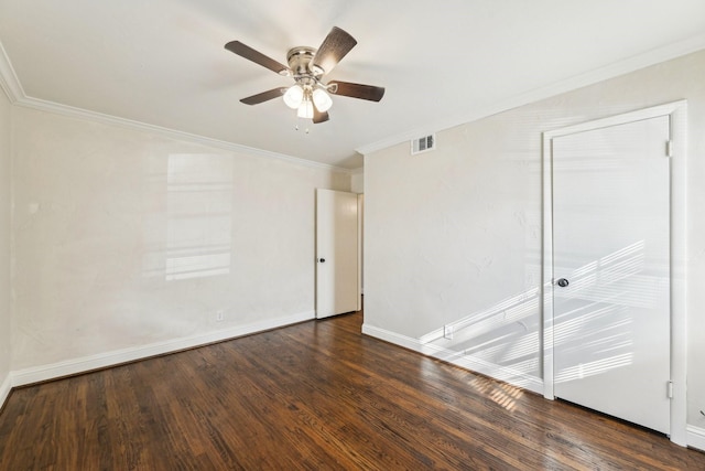 unfurnished room featuring dark hardwood / wood-style floors, ceiling fan, and ornamental molding