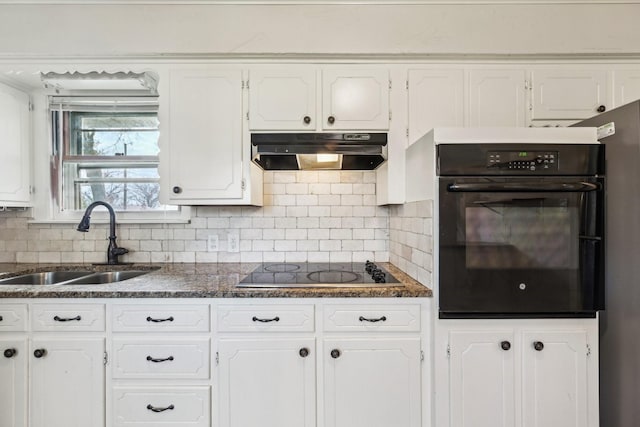 kitchen with electric stovetop, white cabinetry, oven, and sink