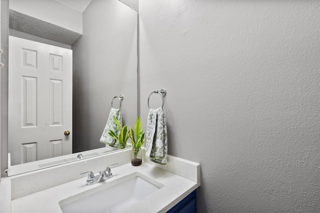 bathroom with vanity and a textured ceiling