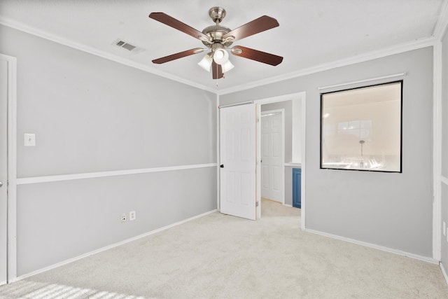 unfurnished bedroom with light colored carpet, ceiling fan, and crown molding