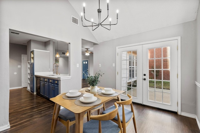 dining room with french doors, sink, dark hardwood / wood-style flooring, high vaulted ceiling, and ceiling fan with notable chandelier