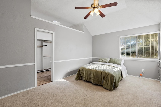 bedroom with carpet flooring, vaulted ceiling, and ceiling fan