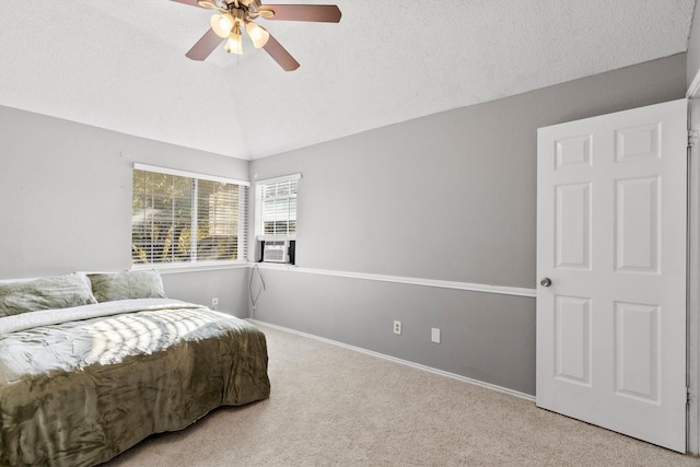 bedroom featuring light carpet, a textured ceiling, vaulted ceiling, and ceiling fan