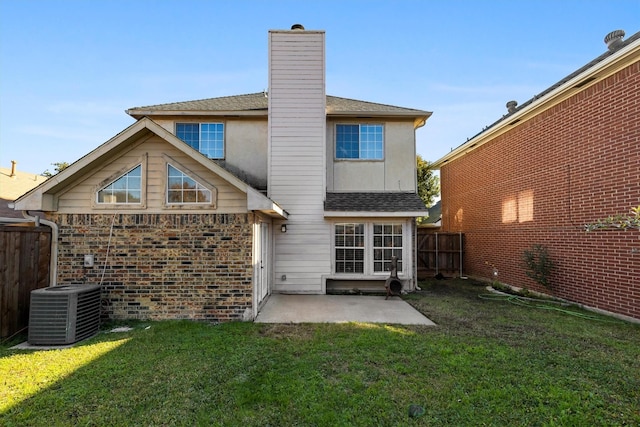 rear view of property with a yard, a patio, and cooling unit