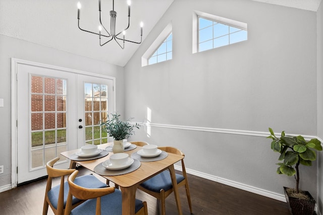 dining room featuring a healthy amount of sunlight, dark hardwood / wood-style flooring, lofted ceiling, and french doors