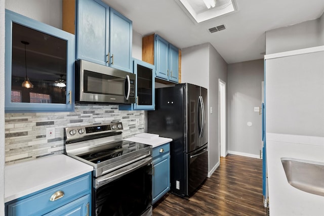 kitchen featuring blue cabinetry, decorative backsplash, dark hardwood / wood-style flooring, and stainless steel appliances