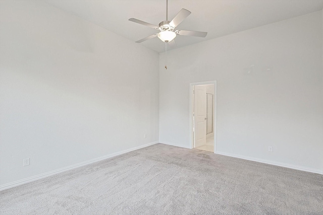 empty room with ceiling fan and light carpet