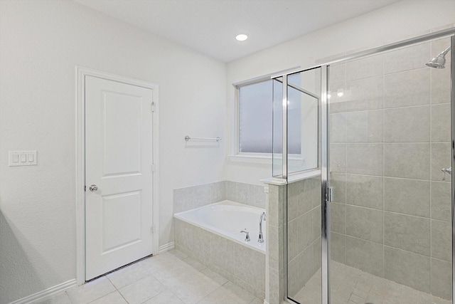 bathroom featuring tile patterned floors and independent shower and bath