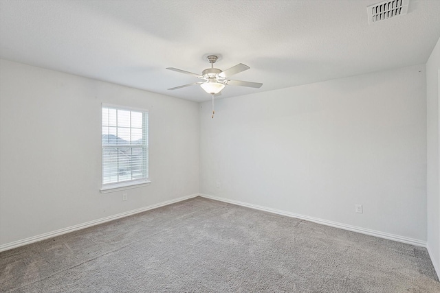 spare room with ceiling fan and carpet floors