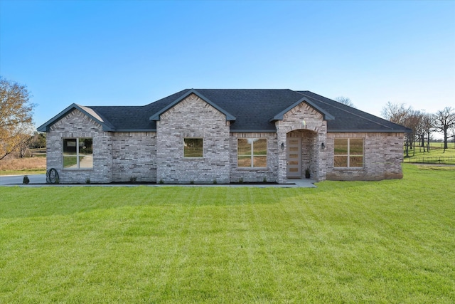 french provincial home with a front yard