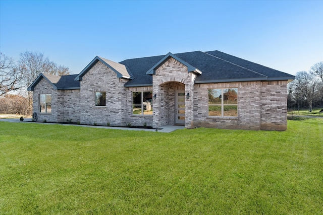 french provincial home with a front lawn