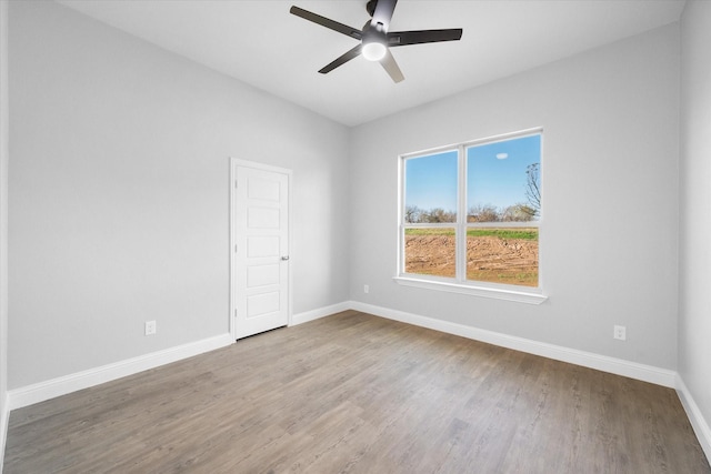 spare room with hardwood / wood-style floors and ceiling fan