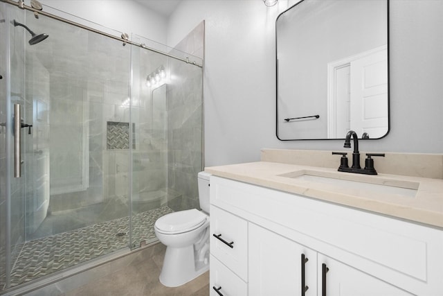 bathroom with walk in shower, tile patterned floors, vanity, and toilet