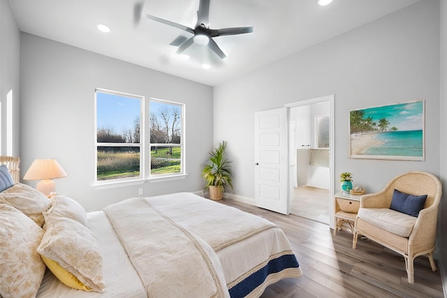 bedroom featuring ceiling fan, wood-type flooring, and ensuite bath