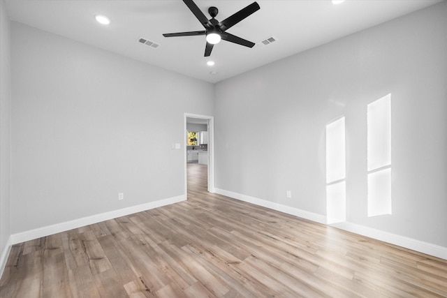 spare room with ceiling fan and light hardwood / wood-style floors