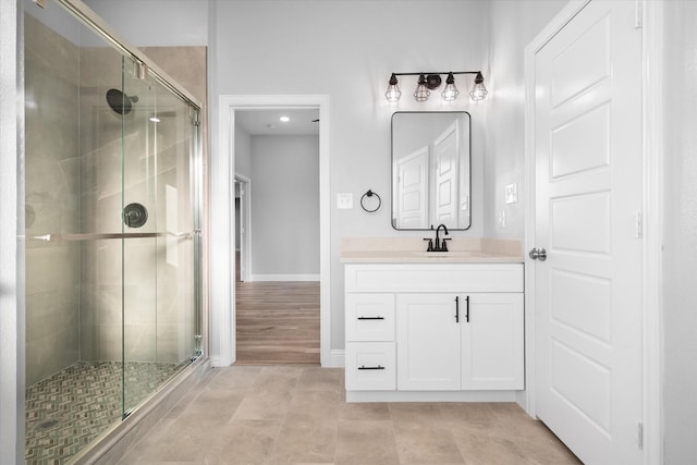 bathroom with vanity, tile patterned flooring, and a shower with door