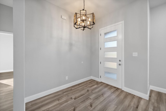 foyer featuring an inviting chandelier and light hardwood / wood-style floors