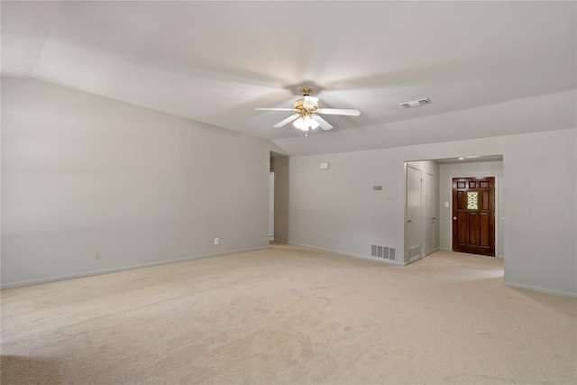 empty room featuring ceiling fan, light colored carpet, and lofted ceiling