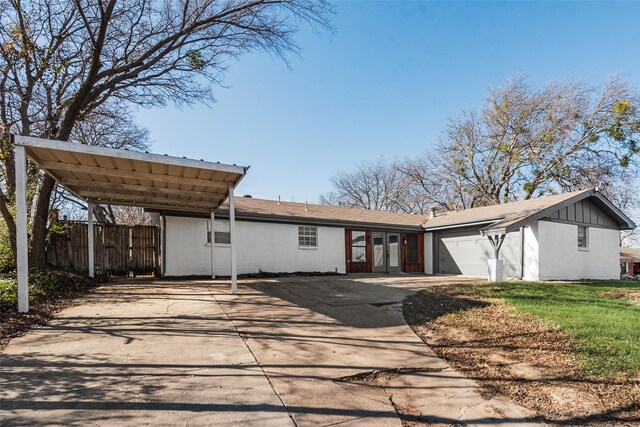 view of front of home with a garage and a carport