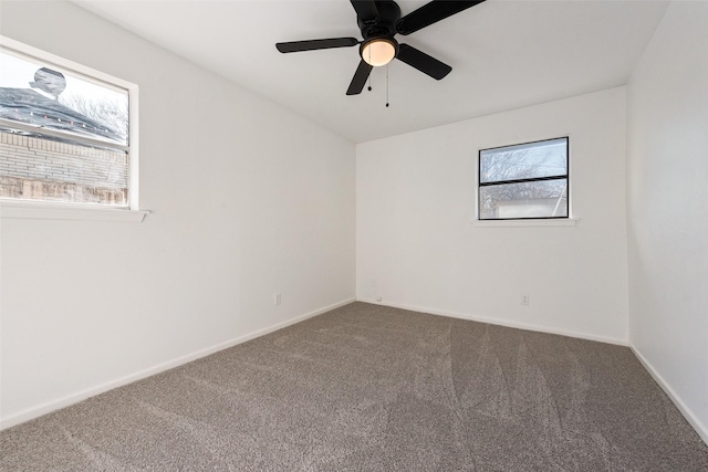 carpeted empty room featuring ceiling fan