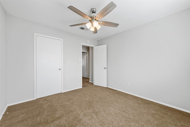 unfurnished bedroom featuring carpet flooring, ceiling fan, and a closet