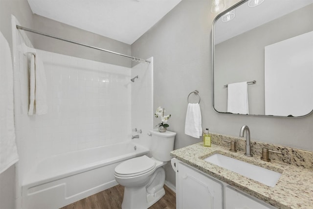 full bathroom with hardwood / wood-style floors, vanity, toilet, and shower / bathtub combination