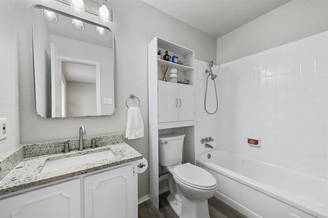 full bathroom with a textured ceiling, vanity, shower / washtub combination, hardwood / wood-style flooring, and toilet