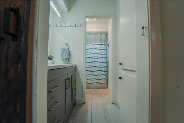 bathroom with a shower with curtain and vanity