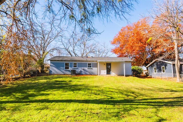 rear view of house featuring a yard