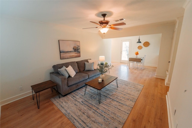 living room with ceiling fan and light wood-type flooring