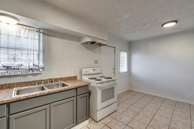 kitchen featuring sink, light tile patterned floors, white range with electric cooktop, gray cabinetry, and a textured ceiling