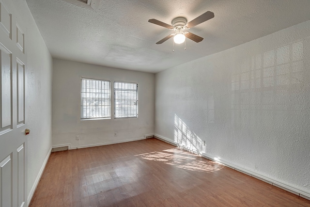 unfurnished room featuring ceiling fan, a textured ceiling, and light wood-type flooring