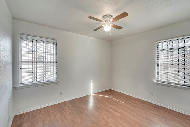 unfurnished room featuring light hardwood / wood-style flooring and ceiling fan