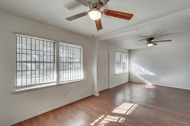 unfurnished room with hardwood / wood-style floors, ceiling fan, and a textured ceiling