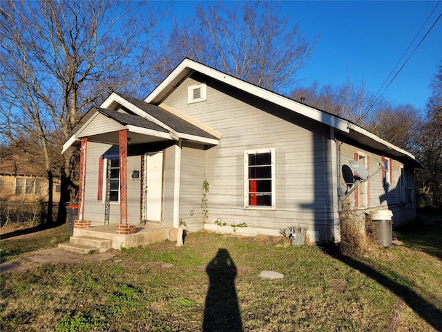 bungalow-style home with a front lawn