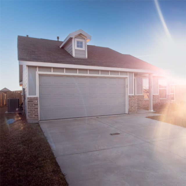 view of front of property with a garage and cooling unit