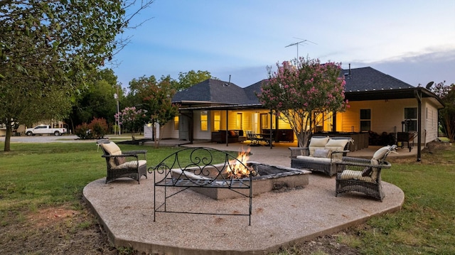 back of property featuring a yard, a patio area, and an outdoor living space with a fire pit