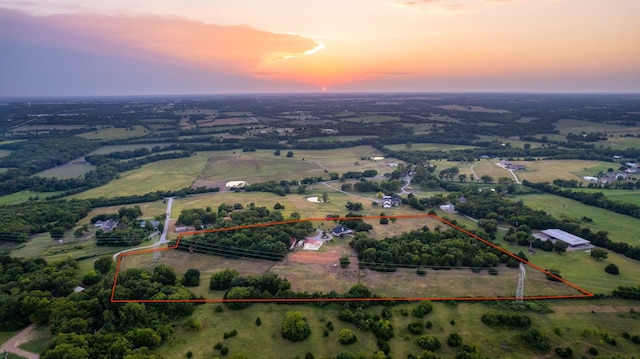 aerial view at dusk featuring a rural view