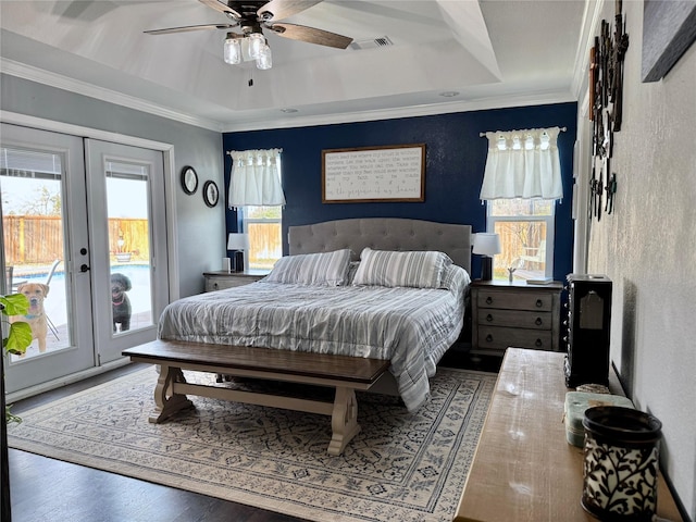 bedroom featuring a tray ceiling, access to outside, french doors, and crown molding