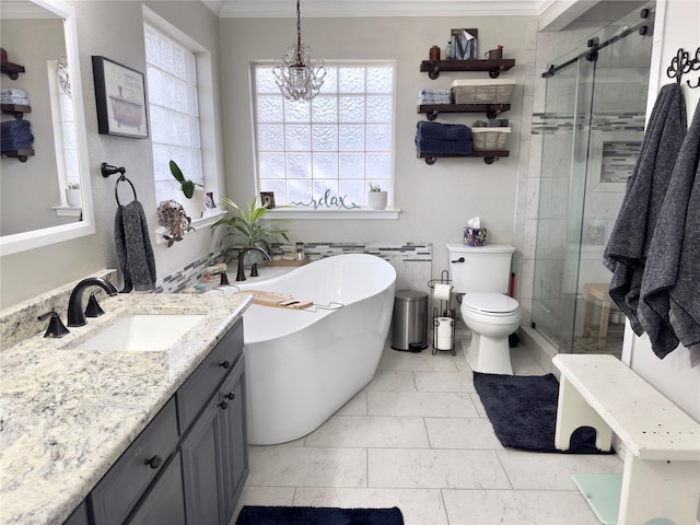 full bath featuring a shower stall, a freestanding bath, vanity, and ornamental molding