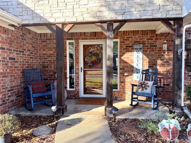 view of exterior entry with covered porch