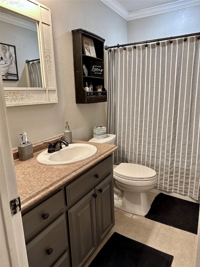 bathroom with vanity, ornamental molding, tile patterned floors, toilet, and a textured wall