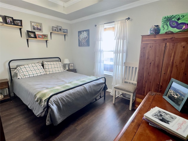 bedroom with ornamental molding and wood finished floors