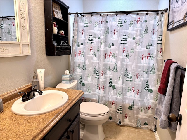 bathroom with tile patterned flooring, vanity, and toilet