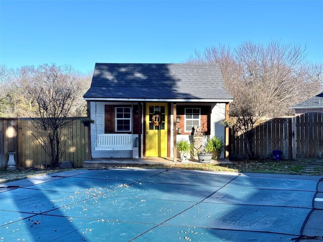 view of patio featuring a covered pool, an outbuilding, and french doors